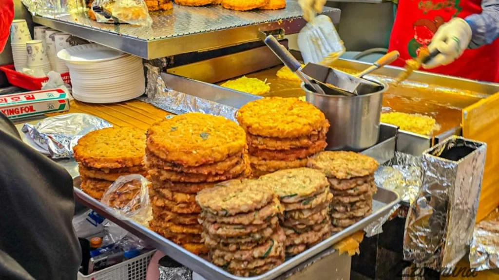 Stacks of fresh mung bean pancakes at a food stall